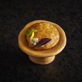 Plantain arepa stuffed with fish and mangrove fruits with seasoning herbs